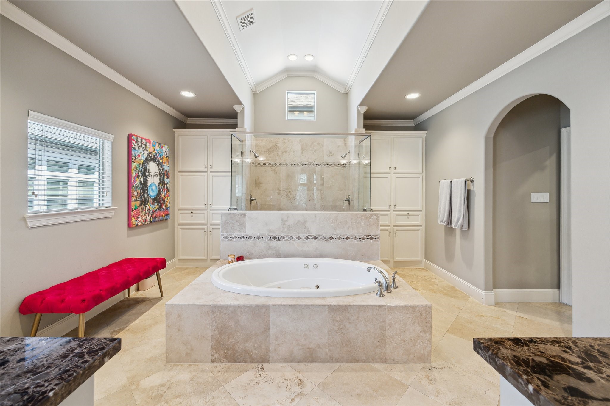 4724 Banning Drive, Unit A Houston, TX 77027 - Photo 26 of 34 A spacious primary bathroom adjoins the retreat, featuring large windows and an oversized shower equipped with multiple showerheads for a luxurious experience.
