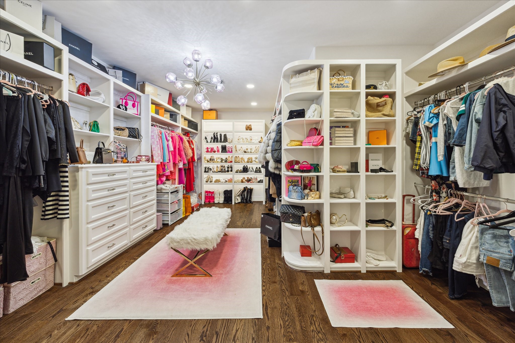 4724 Banning Drive, Unit A Houston, TX 77027 - Photo 28 of 34 Welcome to the extraordinary, custom-designed primary closet—a true haven for the fashion enthusiast. Featuring abundant hanging space and custom built-ins with under-cabinet lighting, it beautifully showcases your shoes, purses, and wardrobe with effortless style.