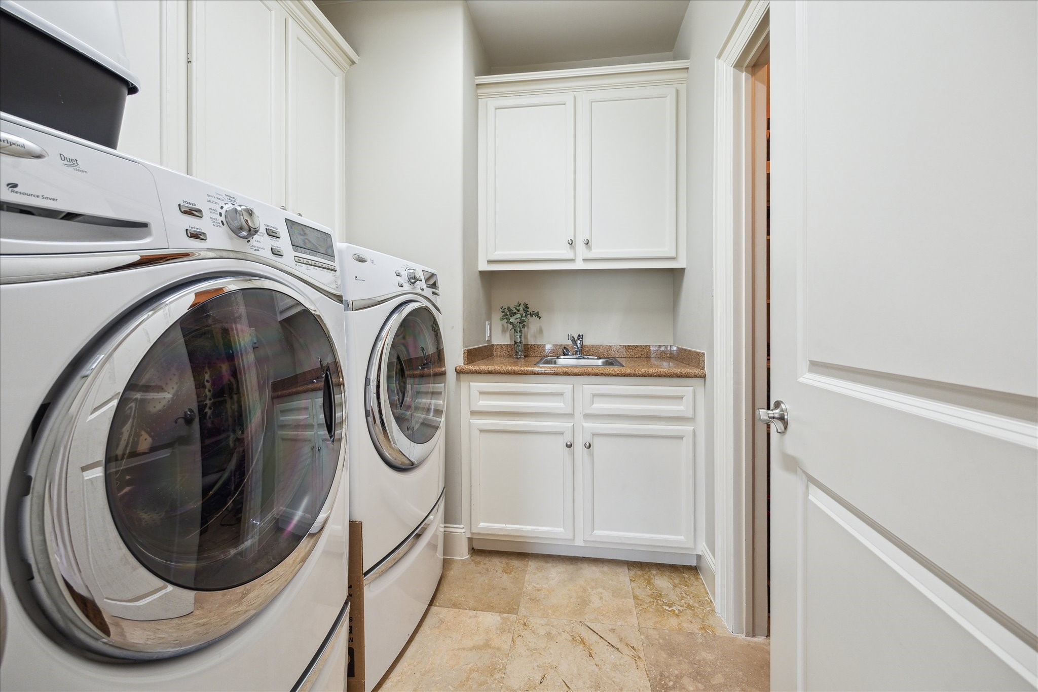 4724 Banning Drive, Unit A Houston, TX 77027 - Photo 29 of 34 A spacious utility room complemented by an expansive walk-in closet, complete with built-in storage shelving that will remain.