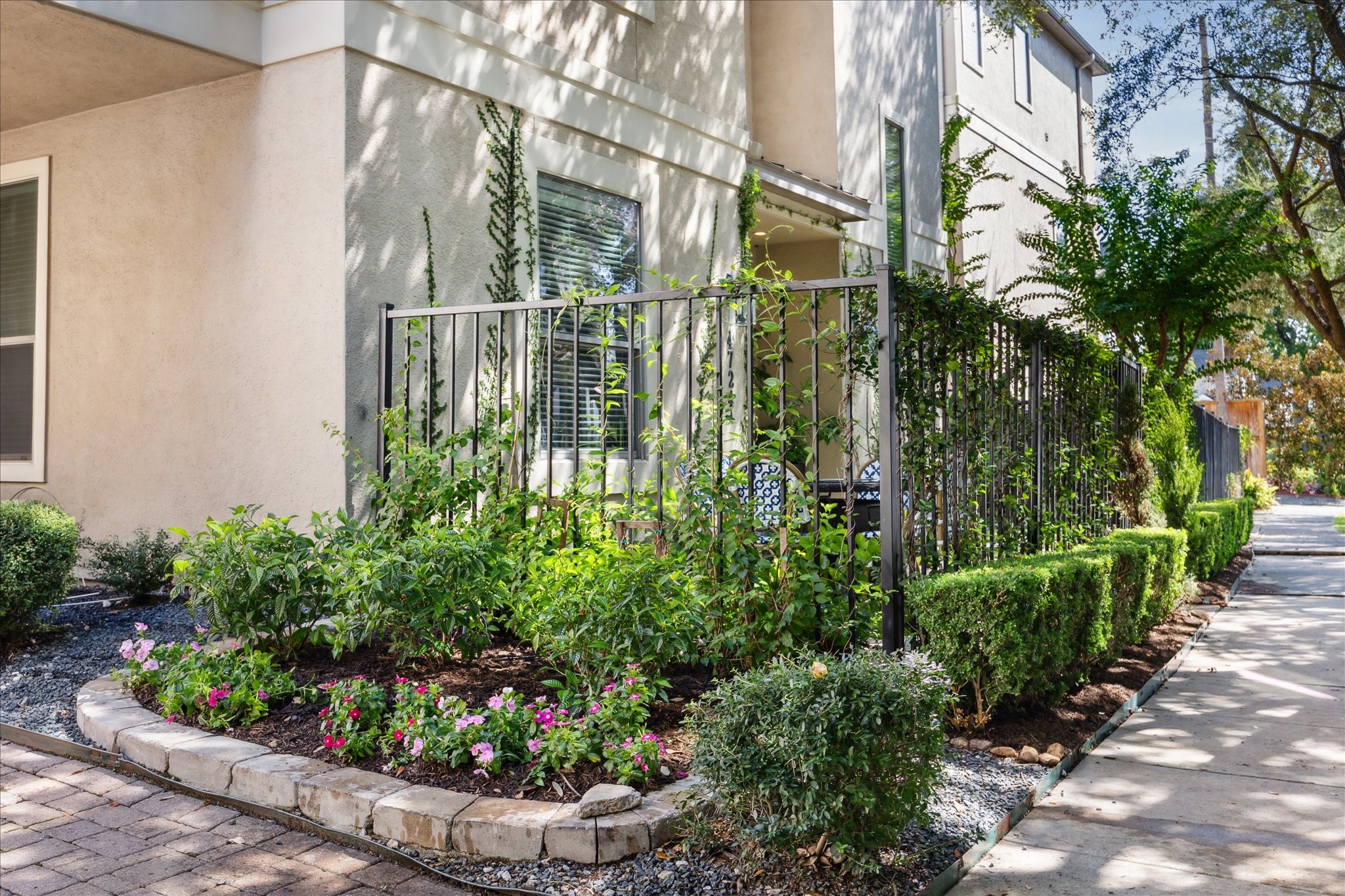 4724 Banning Drive, Unit A Houston, TX 77027 - Photo 3 of 34 Located at the front of the community, this freestanding corner residence offers enhanced privacy and a greater sense of space. Its unique position allows for expanded garden areas and lush landscaping, setting it apart from neighboring homes.