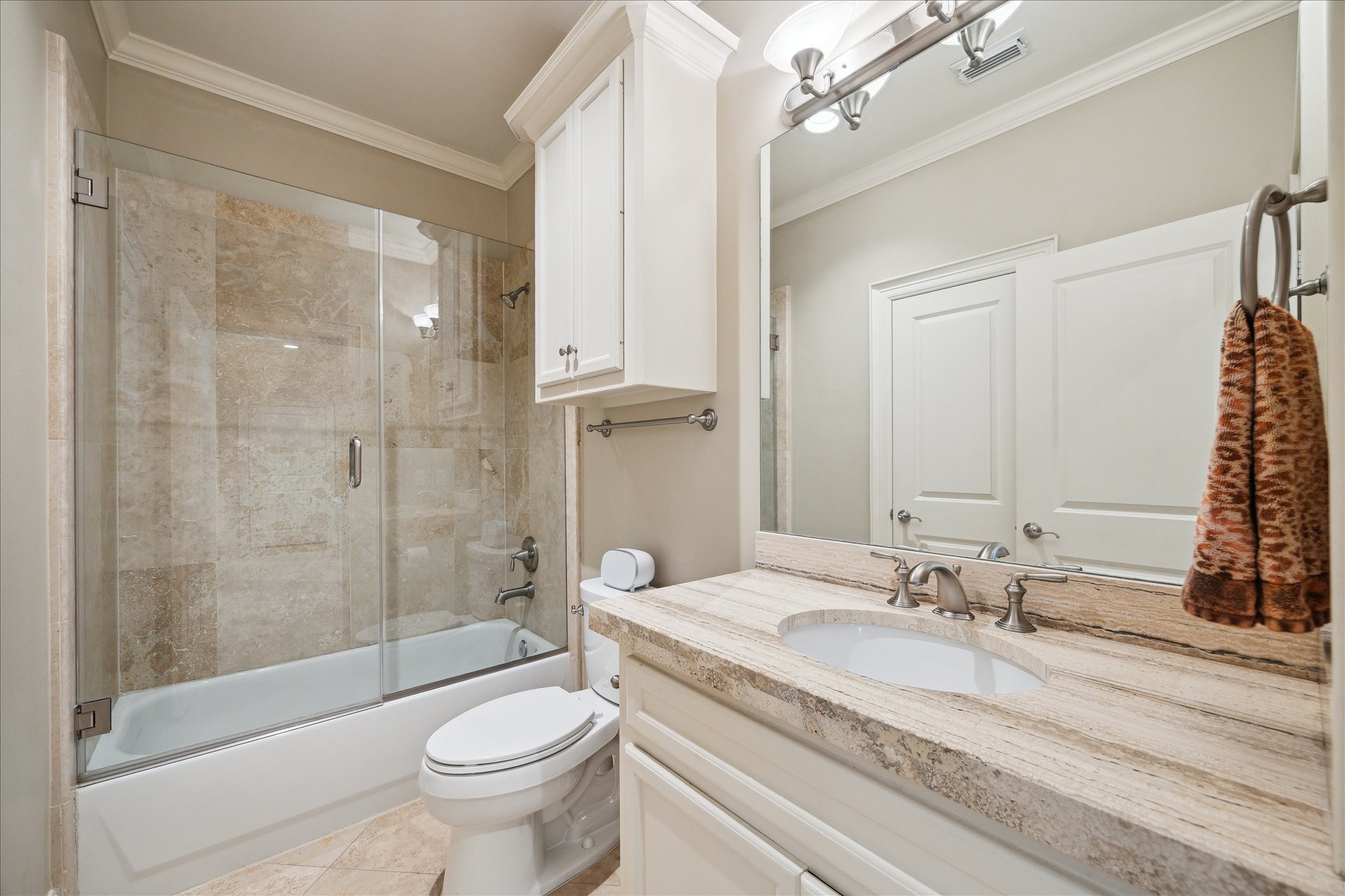 4724 Banning Drive, Unit A Houston, TX 77027 - Photo 9 of 34 The full bathroom on the first floor serves as a shared bath for the two bedrooms downstairs. It features a generous vanity and a tub/shower combination for convenience and comfort.