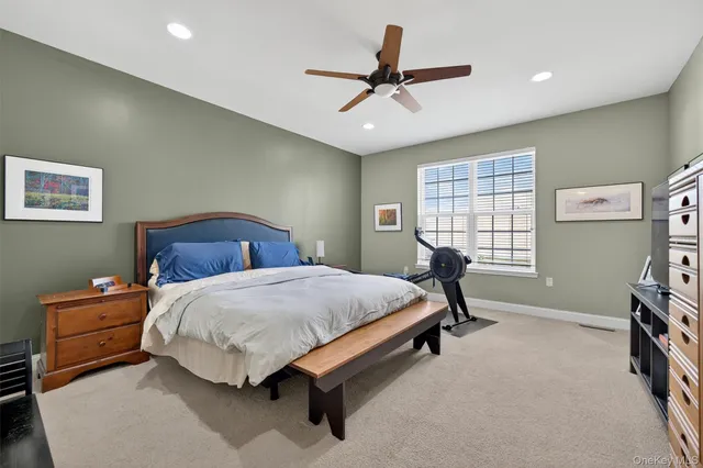 a bedroom with a bed a dresser and a window