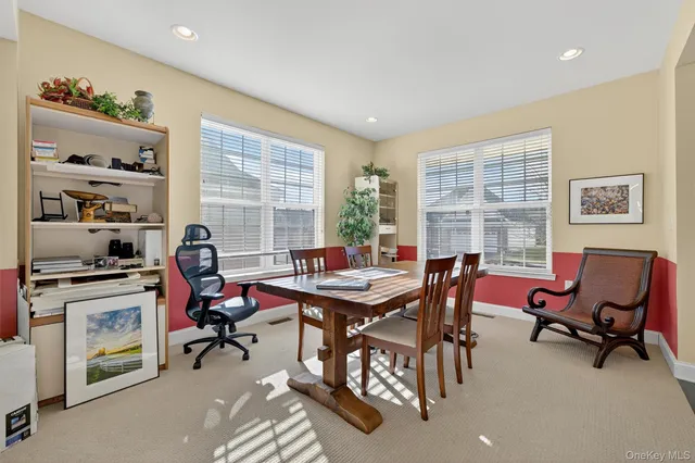 a view of a livingroom with workspace and a window