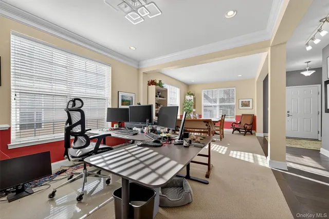a living room with furniture a flat screen tv and a window