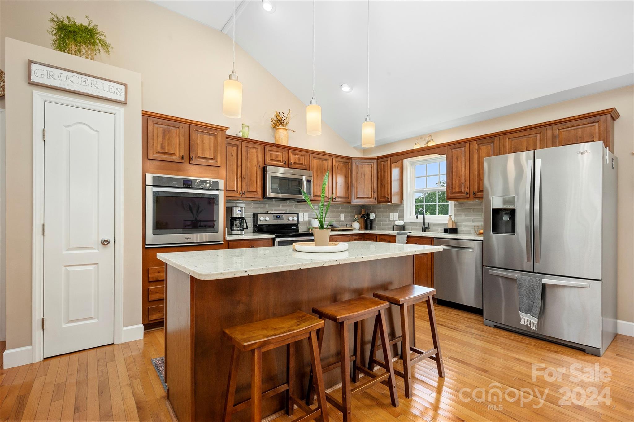 210 Thompson Road Rutherfordton, NC 28139 - Photo 10 of 44 a kitchen with stainless steel appliances granite countertop a refrigerator a stove top oven a sink dishwasher and wooden cabinets with wooden floor