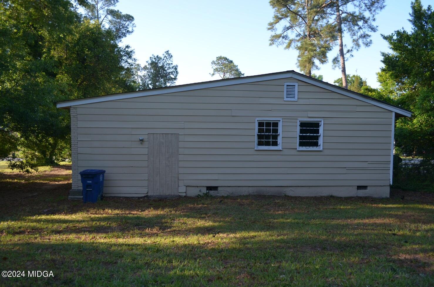 1579 Canterbury Road Macon, GA 31206 - Photo 13 of 15 a view of a backyard with plants and large tree