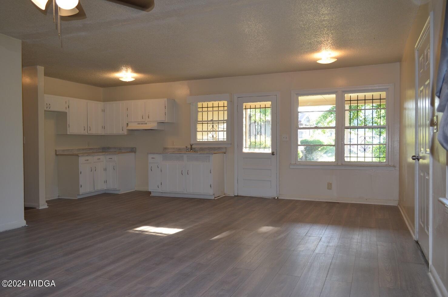 1579 Canterbury Road Macon, GA 31206 - Photo 4 of 15 a view of an empty room with window and wooden floor
