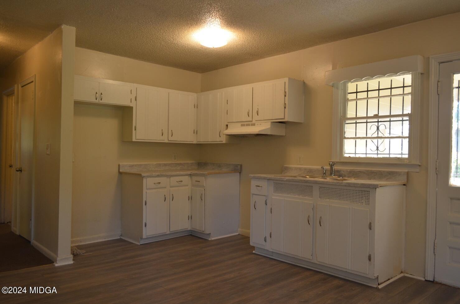 1579 Canterbury Road Macon, GA 31206 - Photo 5 of 15 a kitchen with granite countertop white cabinets and white appliances