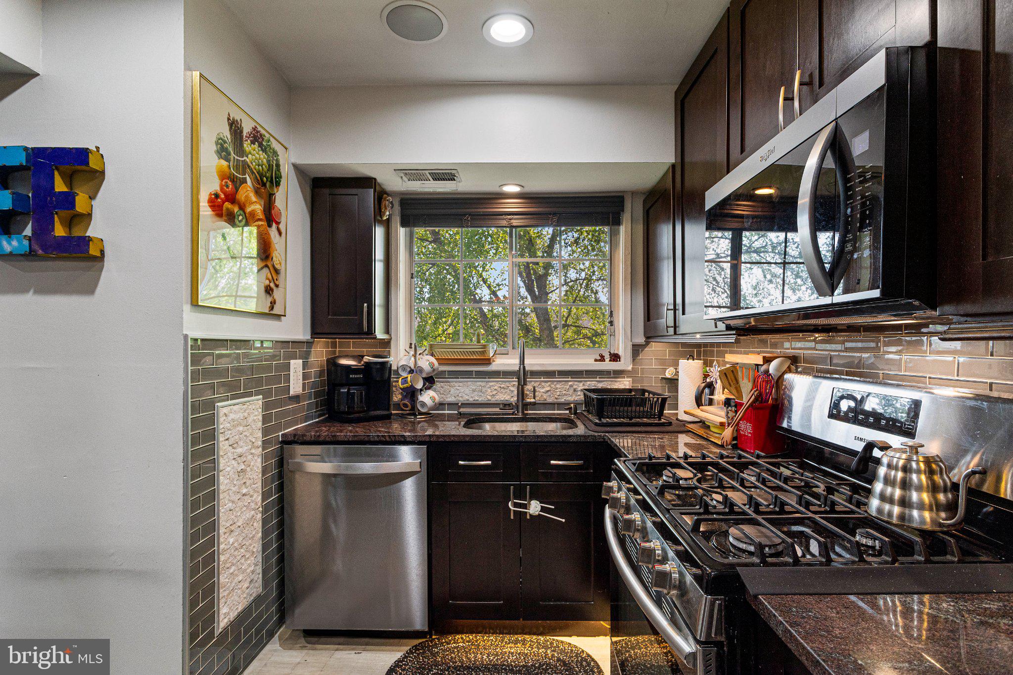 5613 Franconia Road, Unit 303 Alexandria, VA 22310 - Photo 13 of 27 a kitchen with stainless steel appliances granite countertop a stove and a sink