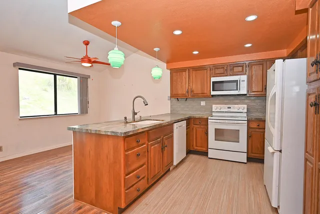 a kitchen with stainless steel appliances granite countertop a stove and a sink