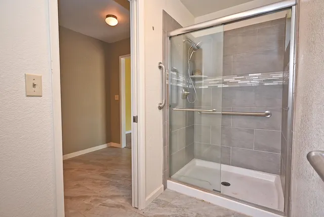 a bathroom with a glass shower door