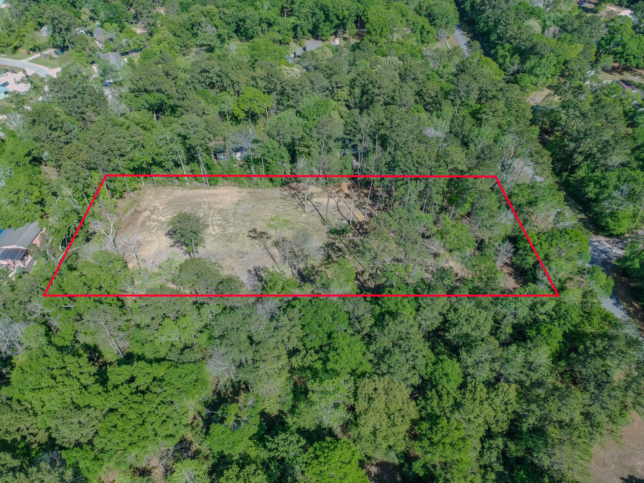 0 Ascot Farms Road Magnolia, TX 77354 - Photo 12 of 12 Space for your custom home amongst the trees at the front and a large building in the back, with room to drive through rather than backing out.