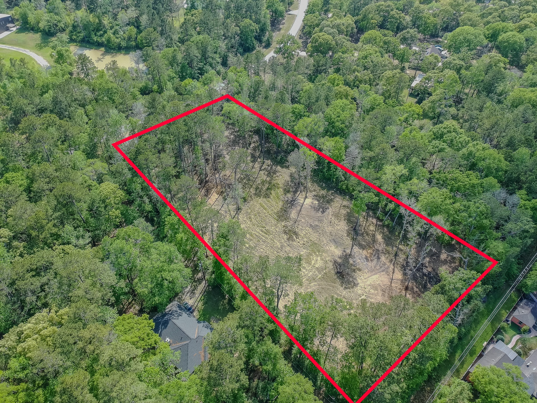 0 Ascot Farms Road Magnolia, TX 77354 - Photo 9 of 12 Aerial view from the back, right corner of the property, showing where a house could be built toward the front where the trees were left, and a barn or shop towards the back. Horses are allowed, 1 per acre.