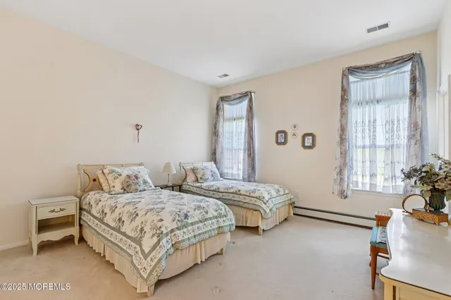 a bedroom with two beds and a couch