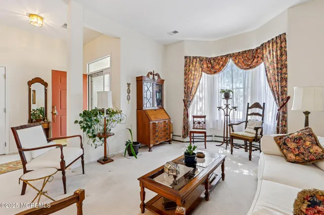 a living room with furniture and a painting