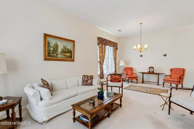a living room with furniture a rug and a chandelier