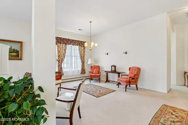 a living room with furniture a window and a chandelier