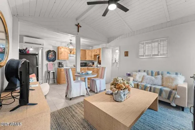 a living room with furniture and a chandelier