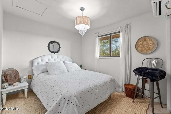 a bedroom with a bed and a chair