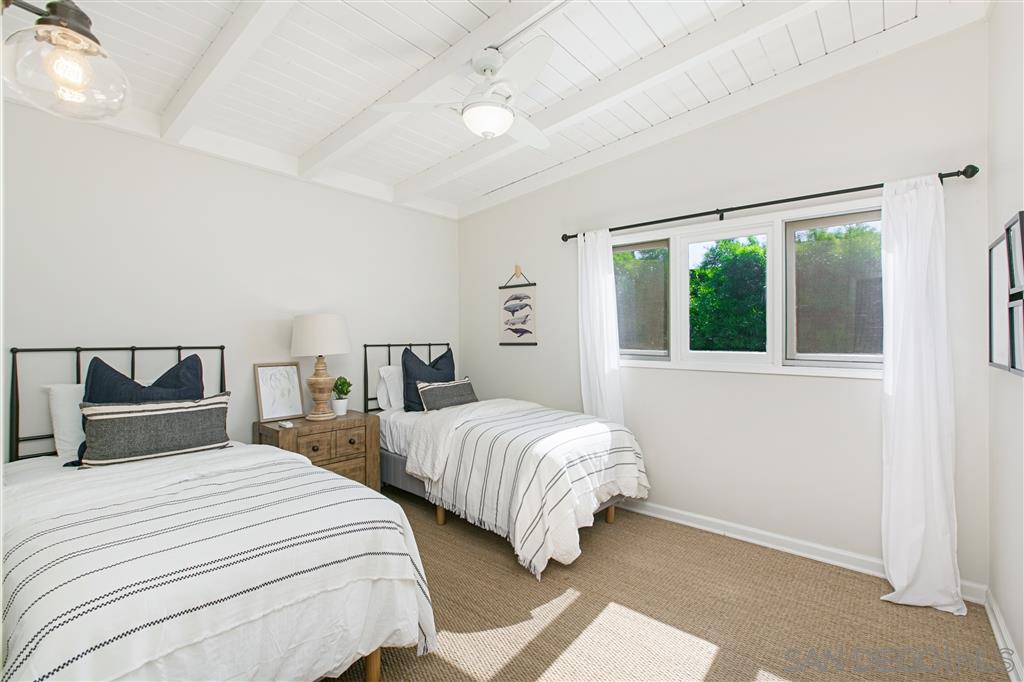 759 Bellevue Place La Jolla, CA 92037 - Photo 9 of 15 a bedroom with two beds and a large window