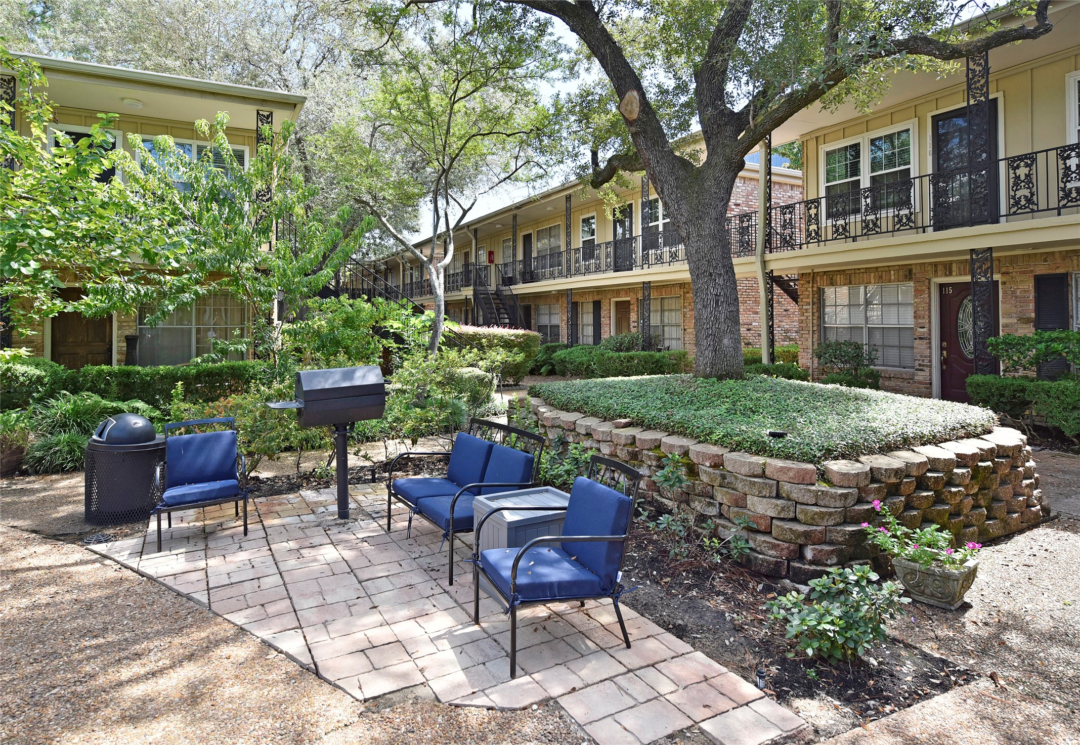 3224 Timmons Lane, Unit 112 Houston, TX 77027 - Photo 1 of 30 a view of a patio with a table and chairs and plants