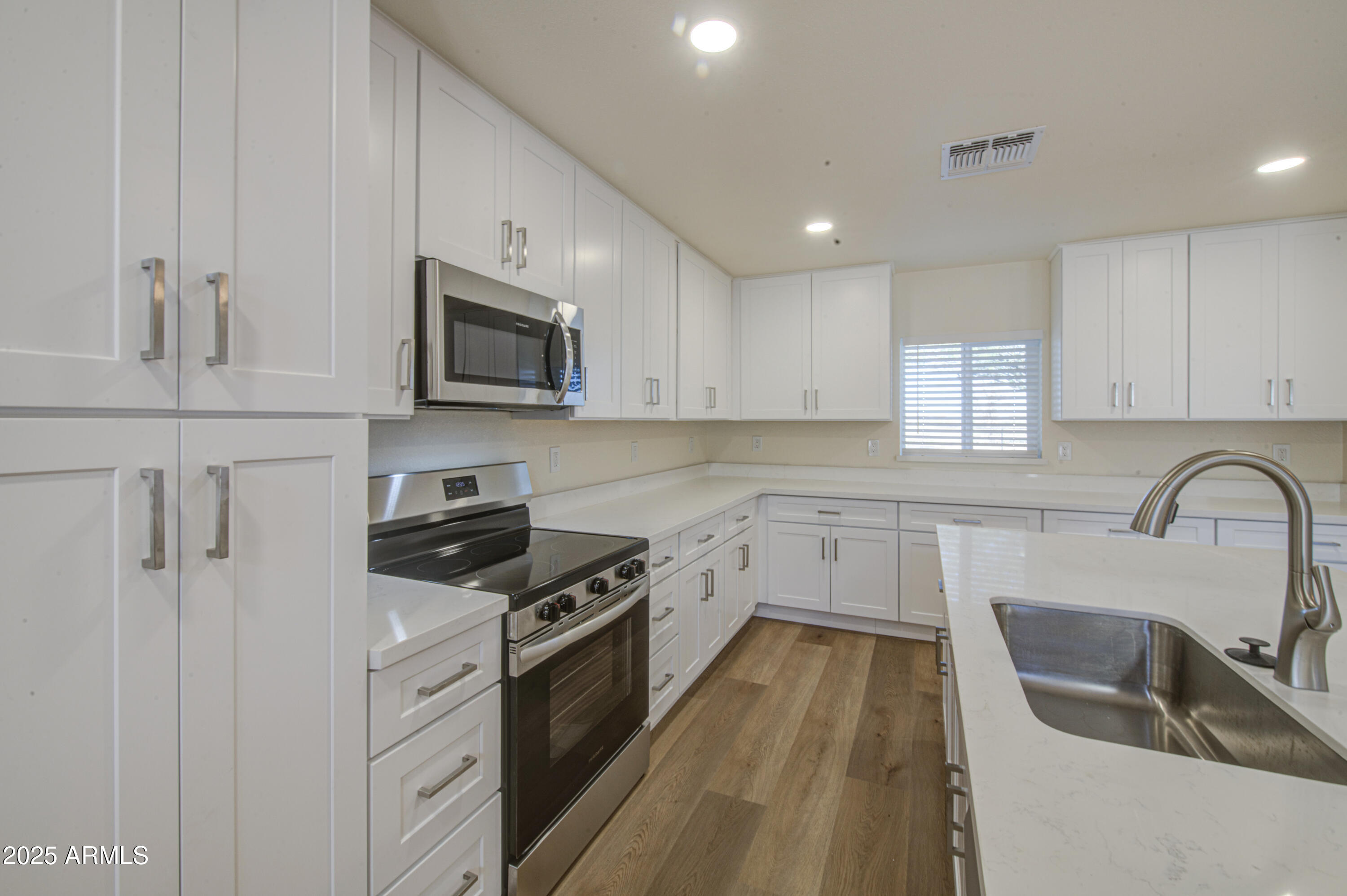 25450 West Clayton Road Casa Grande, AZ 85193 - Photo 21 of 80 a kitchen with granite countertop a stove a sink and a microwave