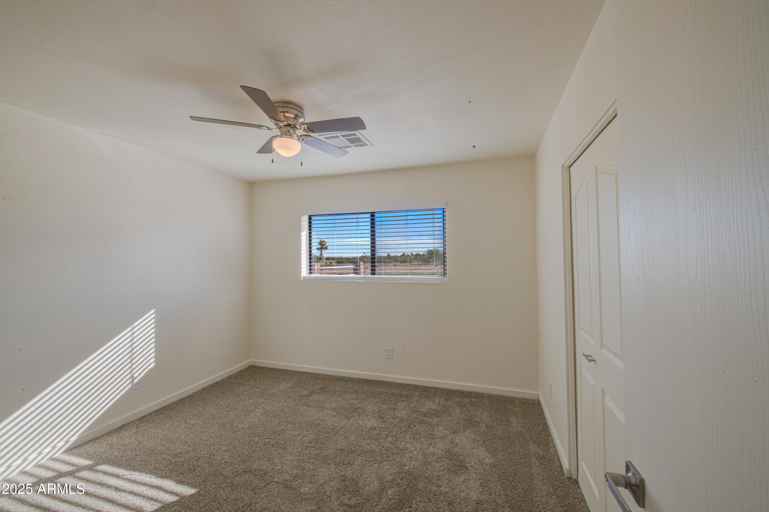 25450 West Clayton Road Casa Grande, AZ 85193 - Photo 31 of 80 an empty room with a window and a ceiling fan