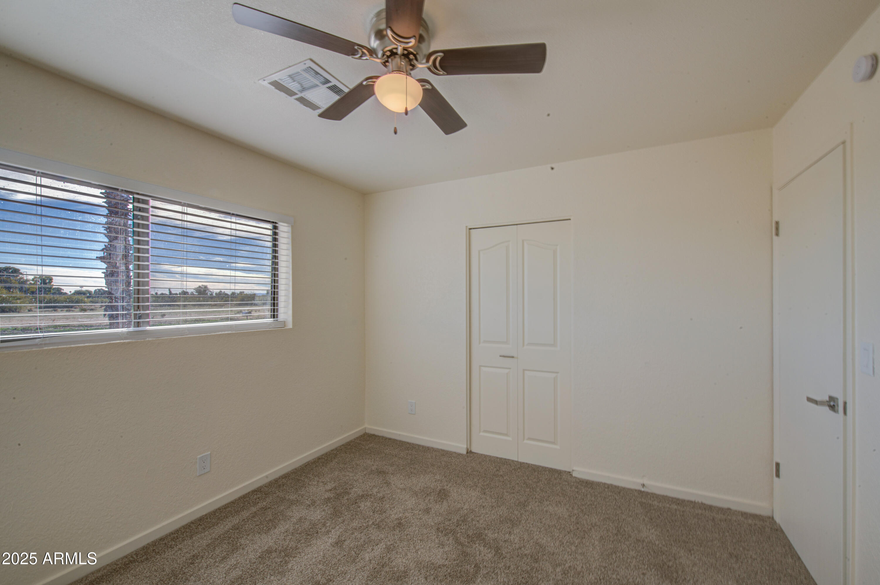25450 West Clayton Road Casa Grande, AZ 85193 - Photo 32 of 80 en empty room with windows and ceiling fan
