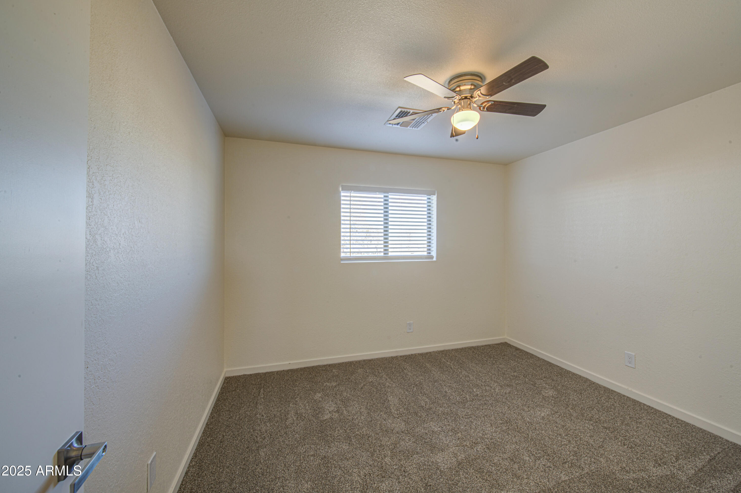 25450 West Clayton Road Casa Grande, AZ 85193 - Photo 33 of 80 an empty room with a window and a fan