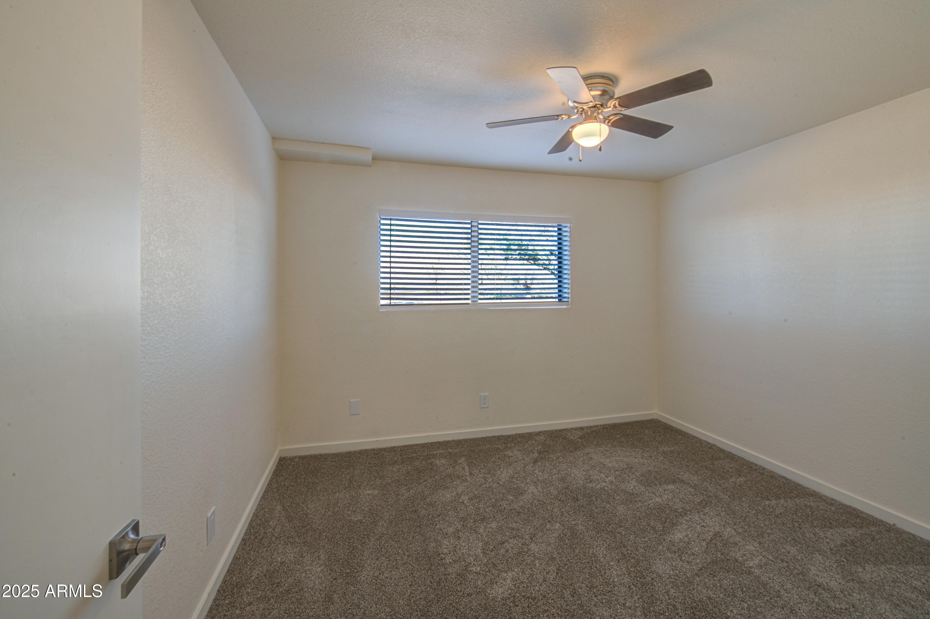 25450 West Clayton Road Casa Grande, AZ 85193 - Photo 35 of 80 an empty room with a window and a ceiling fan