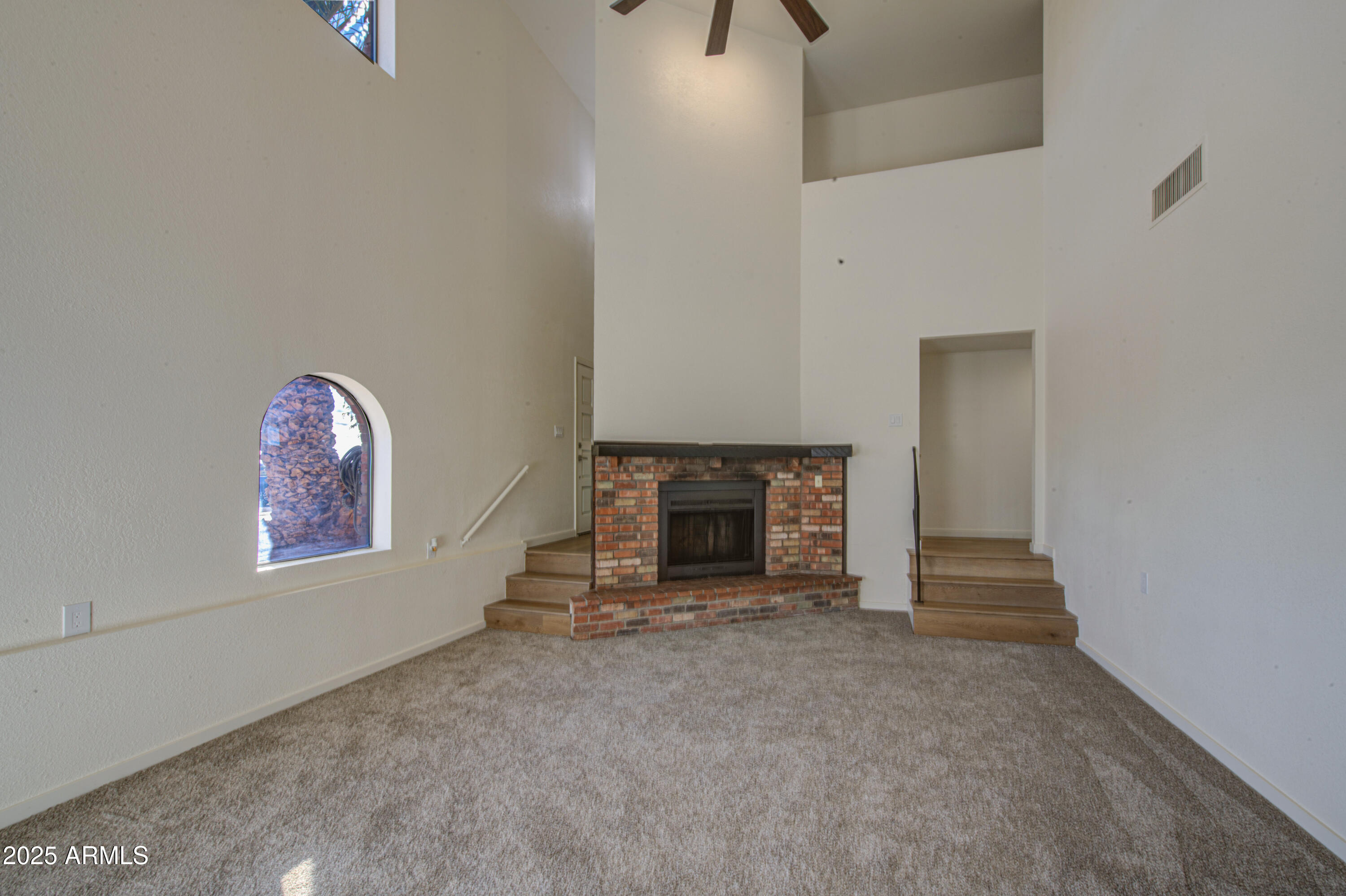 25450 West Clayton Road Casa Grande, AZ 85193 - Photo 5 of 80 a view of an empty room with a fireplace and a window