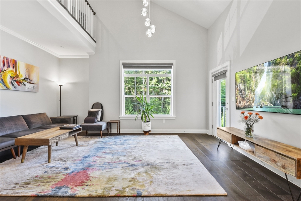 635 Old Post Road, Unit 303 Sharon, MA 02067 - Photo 11 of 33 a living room with furniture and a large window