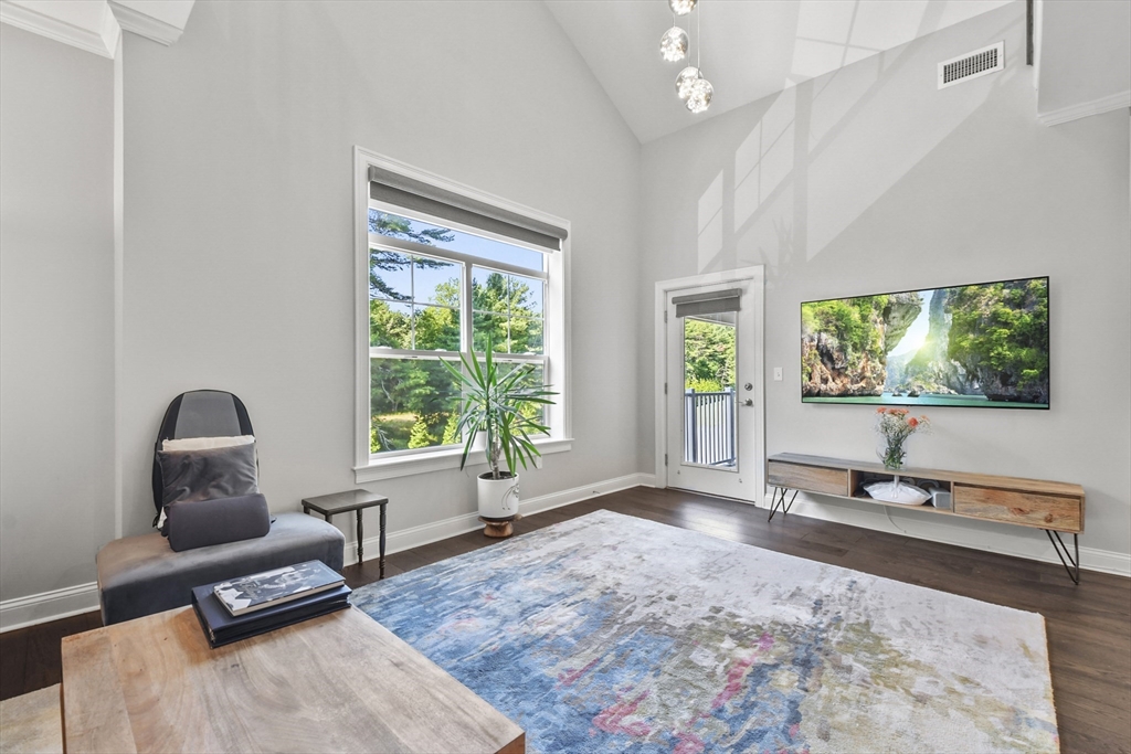 635 Old Post Road, Unit 303 Sharon, MA 02067 - Photo 12 of 33 a living room with furniture and a window