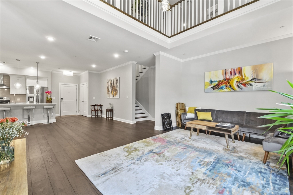 635 Old Post Road, Unit 303 Sharon, MA 02067 - Photo 14 of 33 a living room with furniture and wooden floor