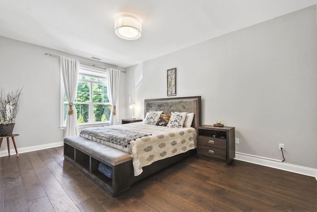 635 Old Post Road, Unit 303 Sharon, MA 02067 - Photo 17 of 33 a bedroom with a bed and a table