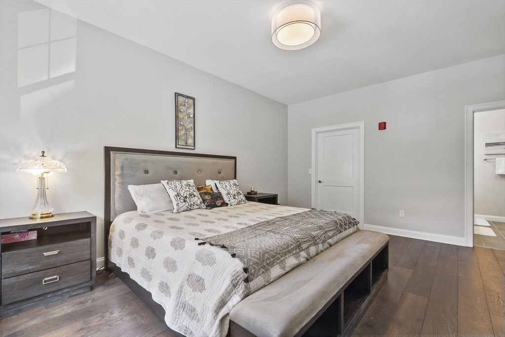 635 Old Post Road, Unit 303 Sharon, MA 02067 - Photo 18 of 33 a bedroom with a bed and a window