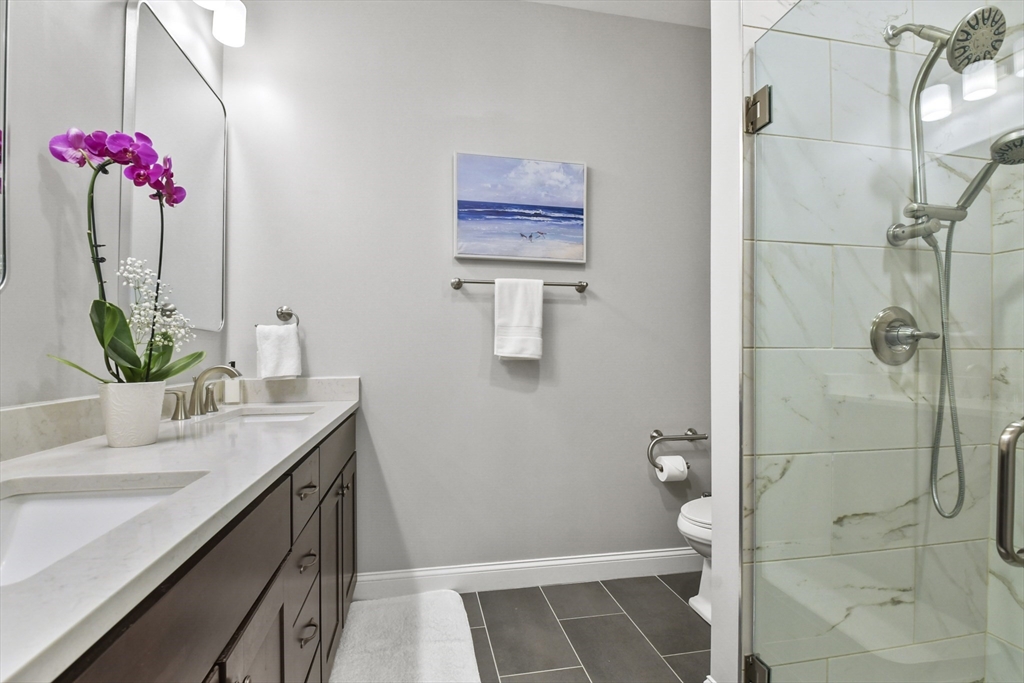 635 Old Post Road, Unit 303 Sharon, MA 02067 - Photo 20 of 33 a bathroom with a shower sink vanity and toilet