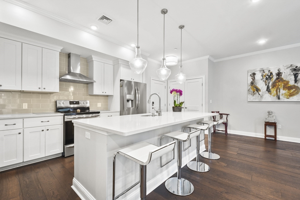 635 Old Post Road, Unit 303 Sharon, MA 02067 - Photo 2 of 33 a large white kitchen with lots of counter space and stainless steel appliances
