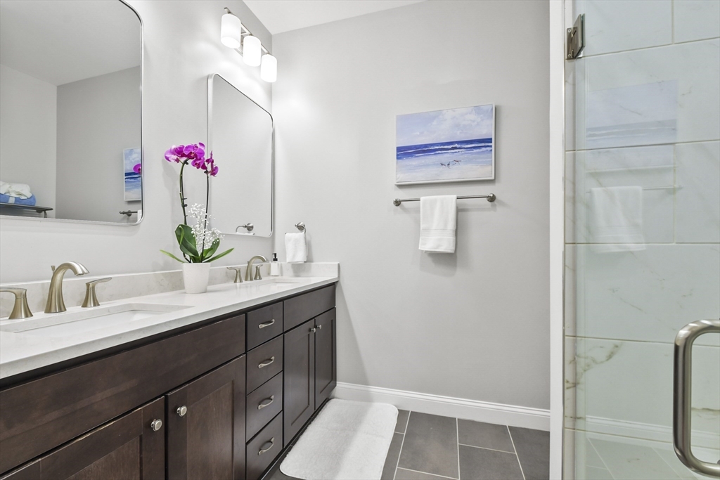 635 Old Post Road, Unit 303 Sharon, MA 02067 - Photo 21 of 33 a bathroom with a sink vanity and mirror