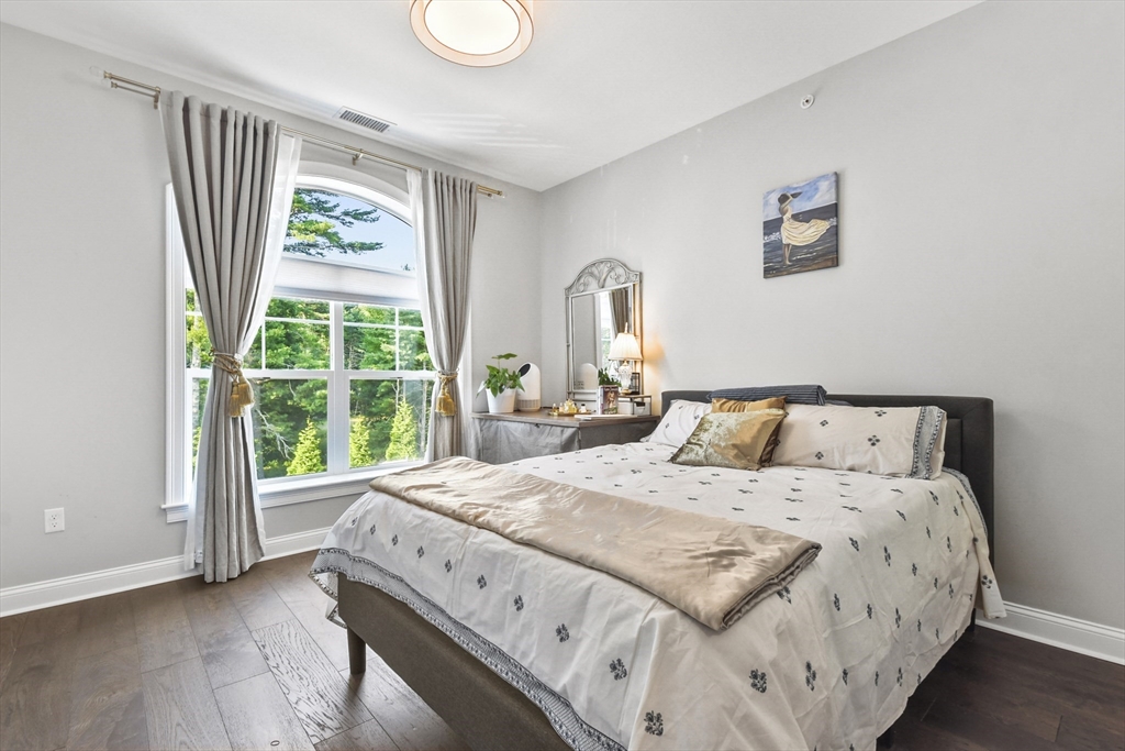 635 Old Post Road, Unit 303 Sharon, MA 02067 - Photo 22 of 33 a large bed sitting in a bedroom next to a window