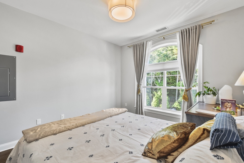 635 Old Post Road, Unit 303 Sharon, MA 02067 - Photo 24 of 33 a bedroom with a bed and a window