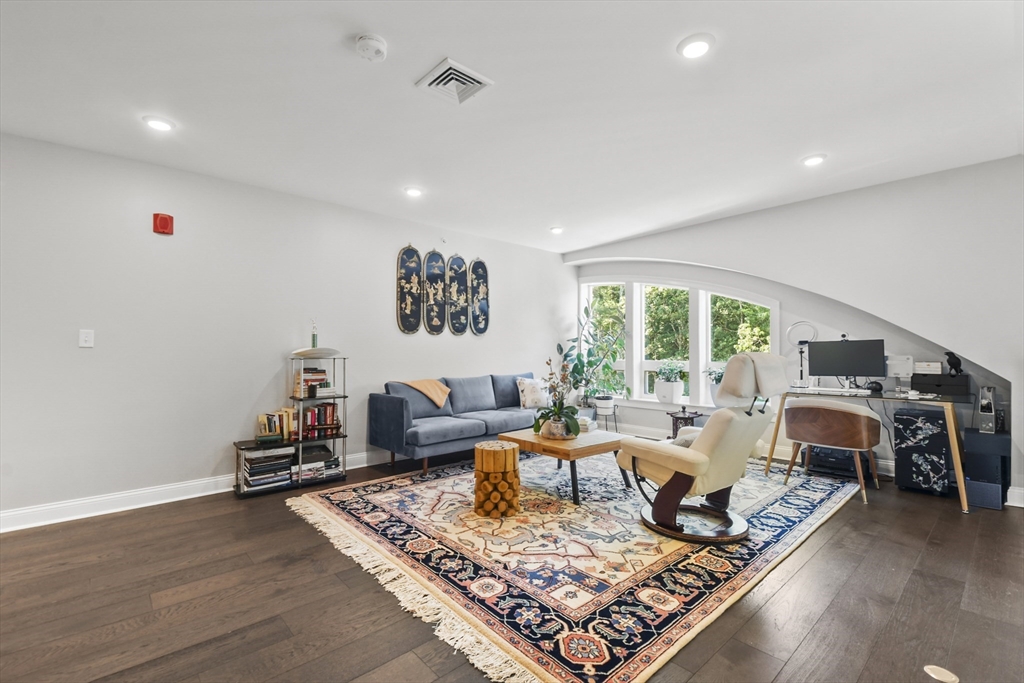 635 Old Post Road, Unit 303 Sharon, MA 02067 - Photo 26 of 33 a living room with furniture and a wooden floor