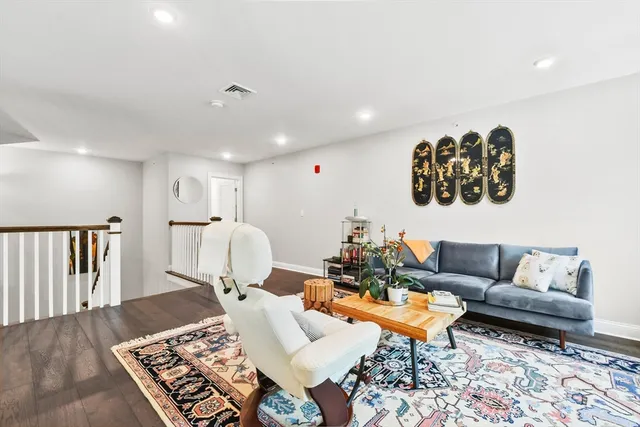 a living room with furniture and a rug