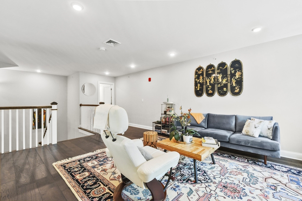 635 Old Post Road, Unit 303 Sharon, MA 02067 - Photo 28 of 33 a living room with furniture and a rug
