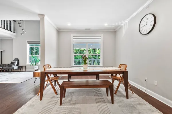 a view of workspace with furniture window and wooden floor