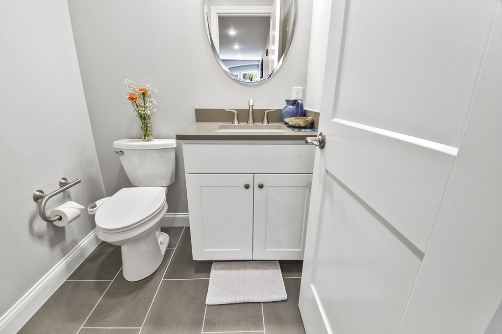 635 Old Post Road, Unit 303 Sharon, MA 02067 - Photo 10 of 33 a bathroom with a toilet a sink and a mirror