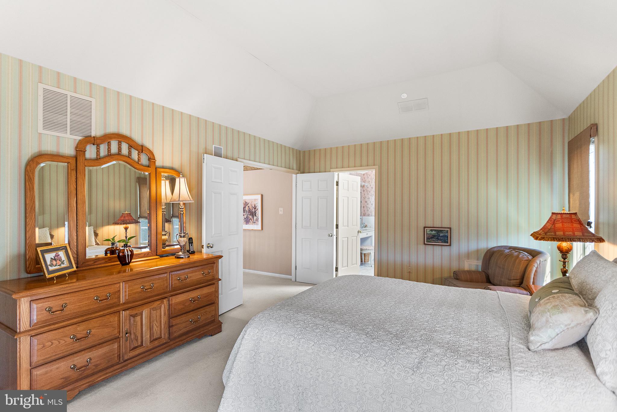 16 Riders Run Newtown Square, PA 19073 - Photo 23 of 49 a bedroom with a bed and a large mirror on dresser