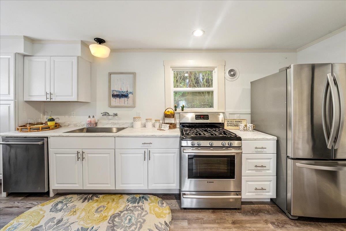 799 Grace Street Monterey, CA 93940 - Photo 8 of 38 a kitchen with a stove a sink and a refrigerator