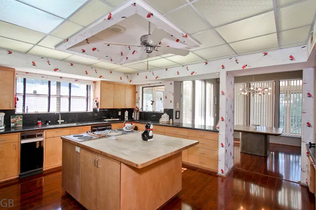 a kitchen with stainless steel appliances granite countertop a sink a stove and a refrigerator