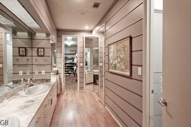 a view of walk in closet with clothes